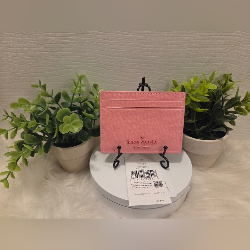 Kate Spade New York Coral Pink Leather Card Case With Floral Embossed Design.